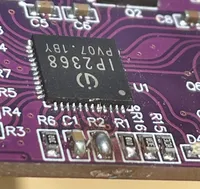 A close up of an IP2368 PCB module with a blob of solder short-circuiting the pads labelled R2