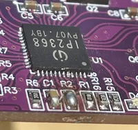 A close up of an IP2368 PCB module with a blob of solder short-circuiting the pads labelled R2